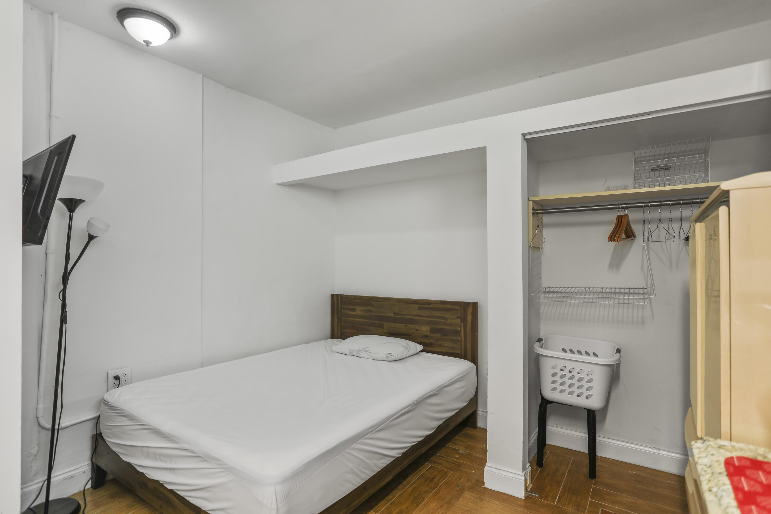 22682 Southwest 65th Avenue Boca Raton, FL 33428 - Photo 27 of 58 a bedroom with a bed and wooden floor