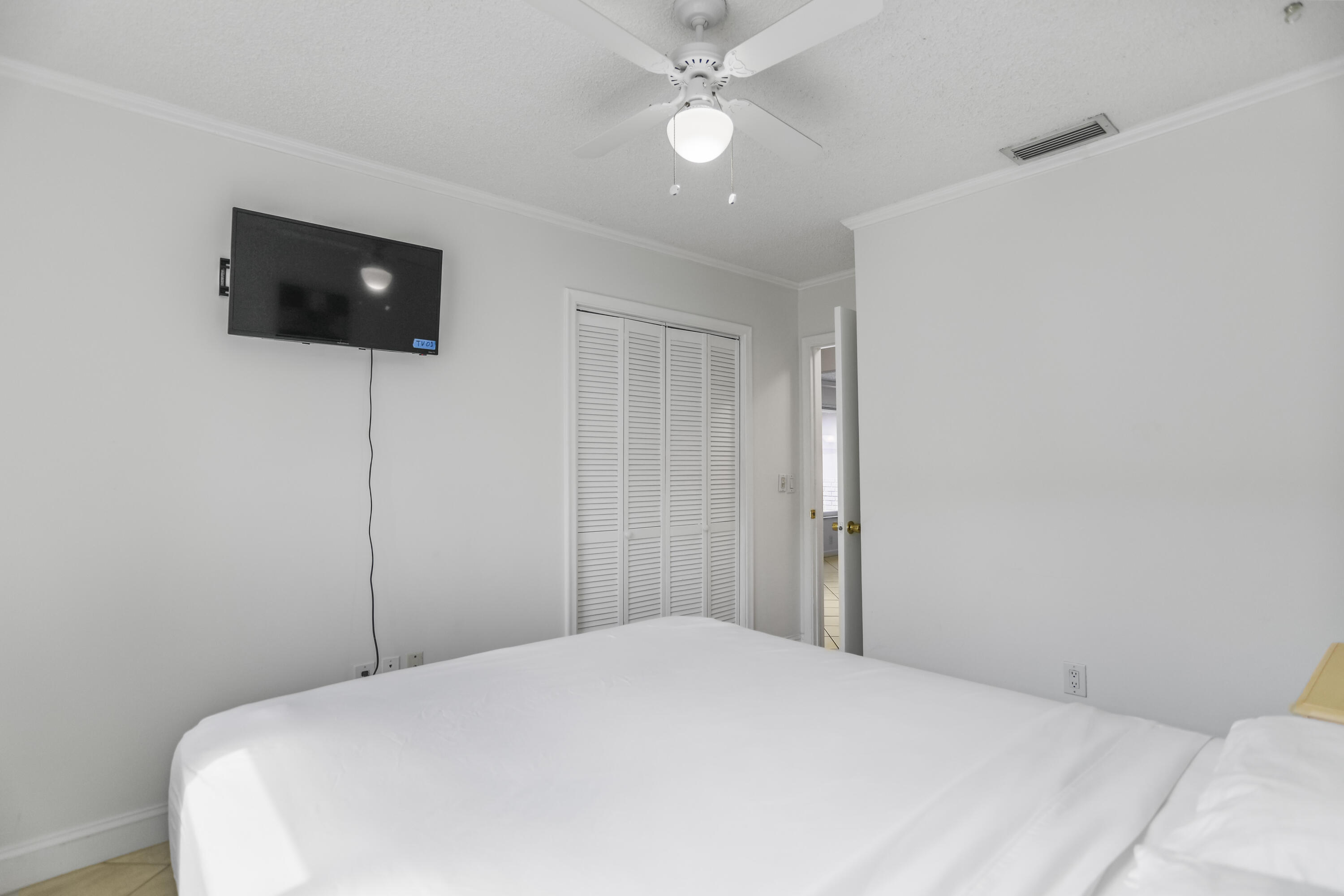 22682 Southwest 65th Avenue Boca Raton, FL 33428 - Photo 28 of 58 a bedroom with a bed and a tv