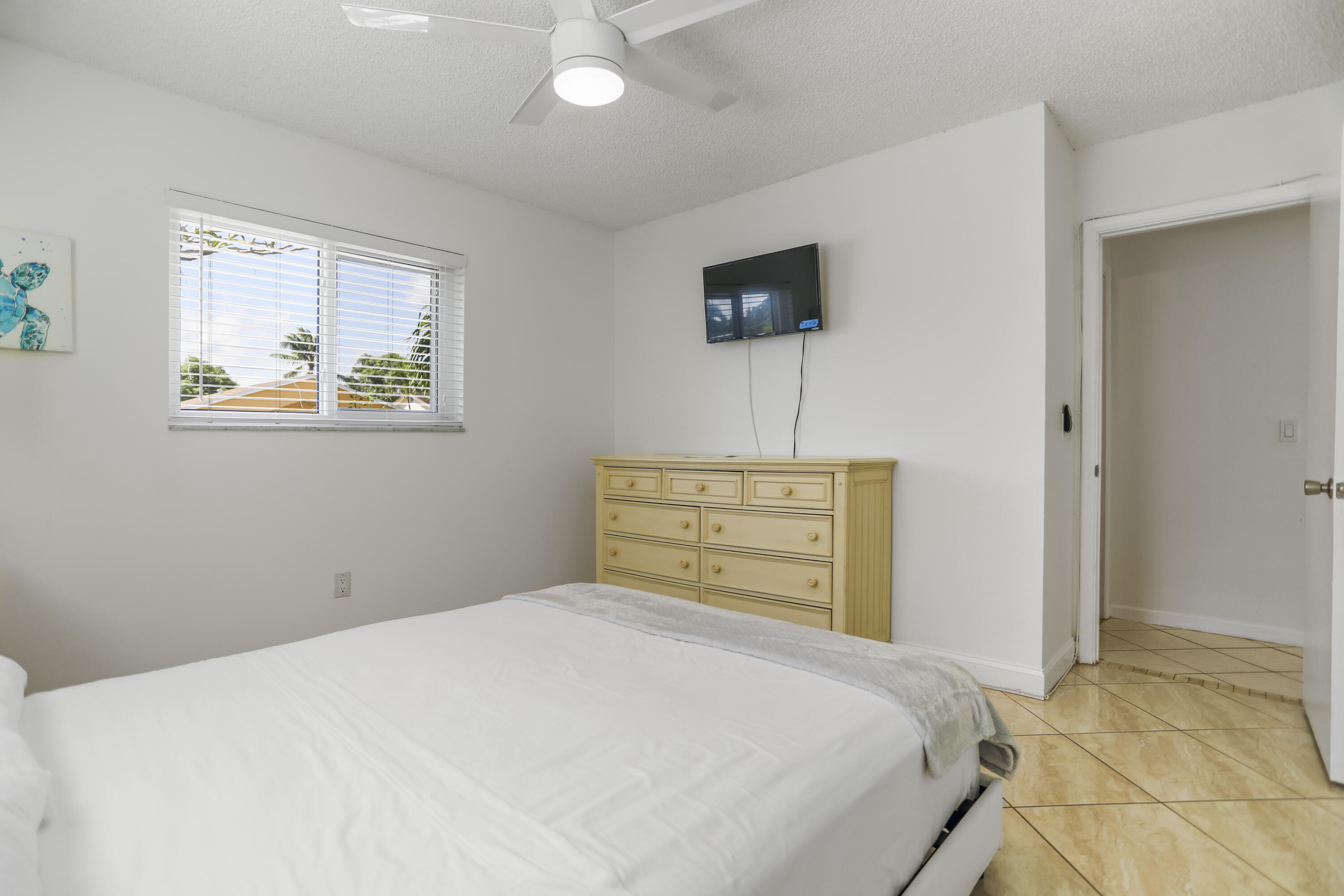 22682 Southwest 65th Avenue Boca Raton, FL 33428 - Photo 30 of 58 a bedroom with a bed and a tv