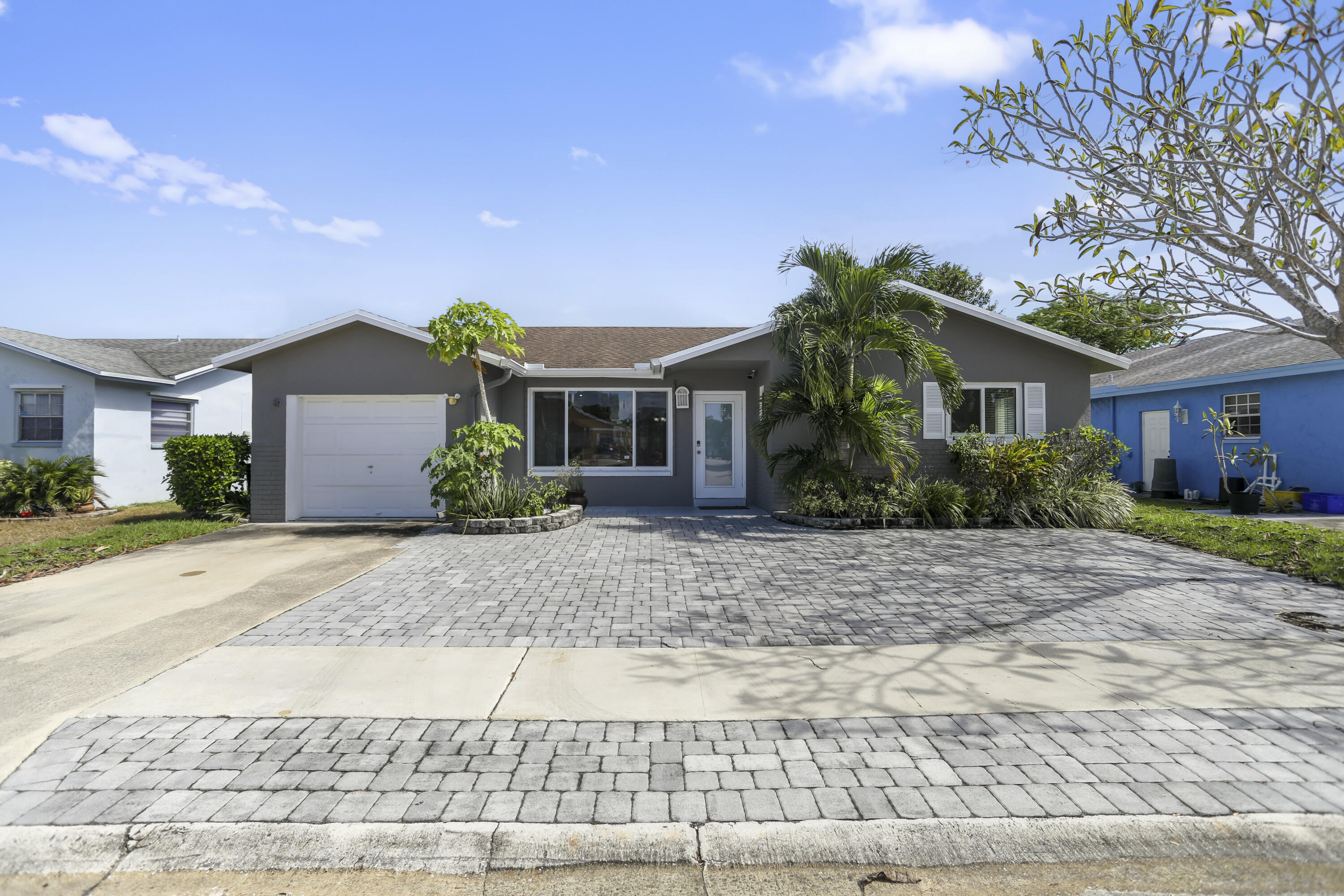 22682 Southwest 65th Avenue Boca Raton, FL 33428 - Photo 3 of 58 front view of house with a yard