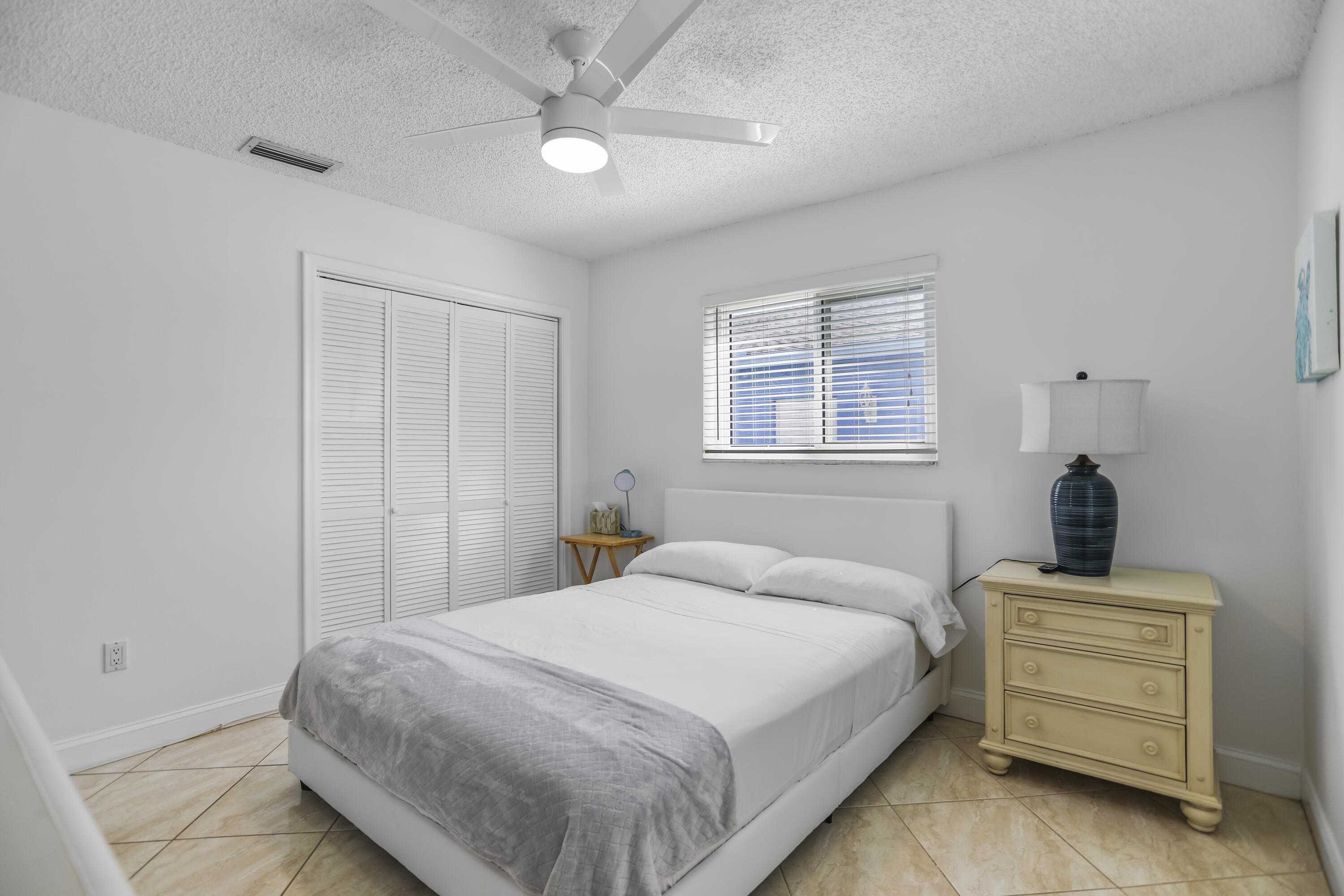 22682 Southwest 65th Avenue Boca Raton, FL 33428 - Photo 32 of 58 a bedroom with a bed and a dresser