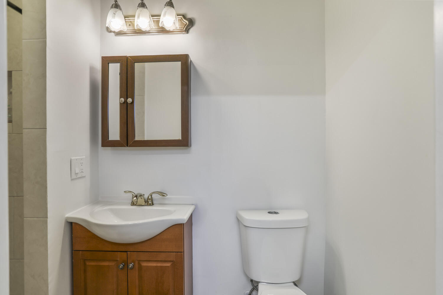 22682 Southwest 65th Avenue Boca Raton, FL 33428 - Photo 33 of 58 a bathroom with a toilet sink and mirror