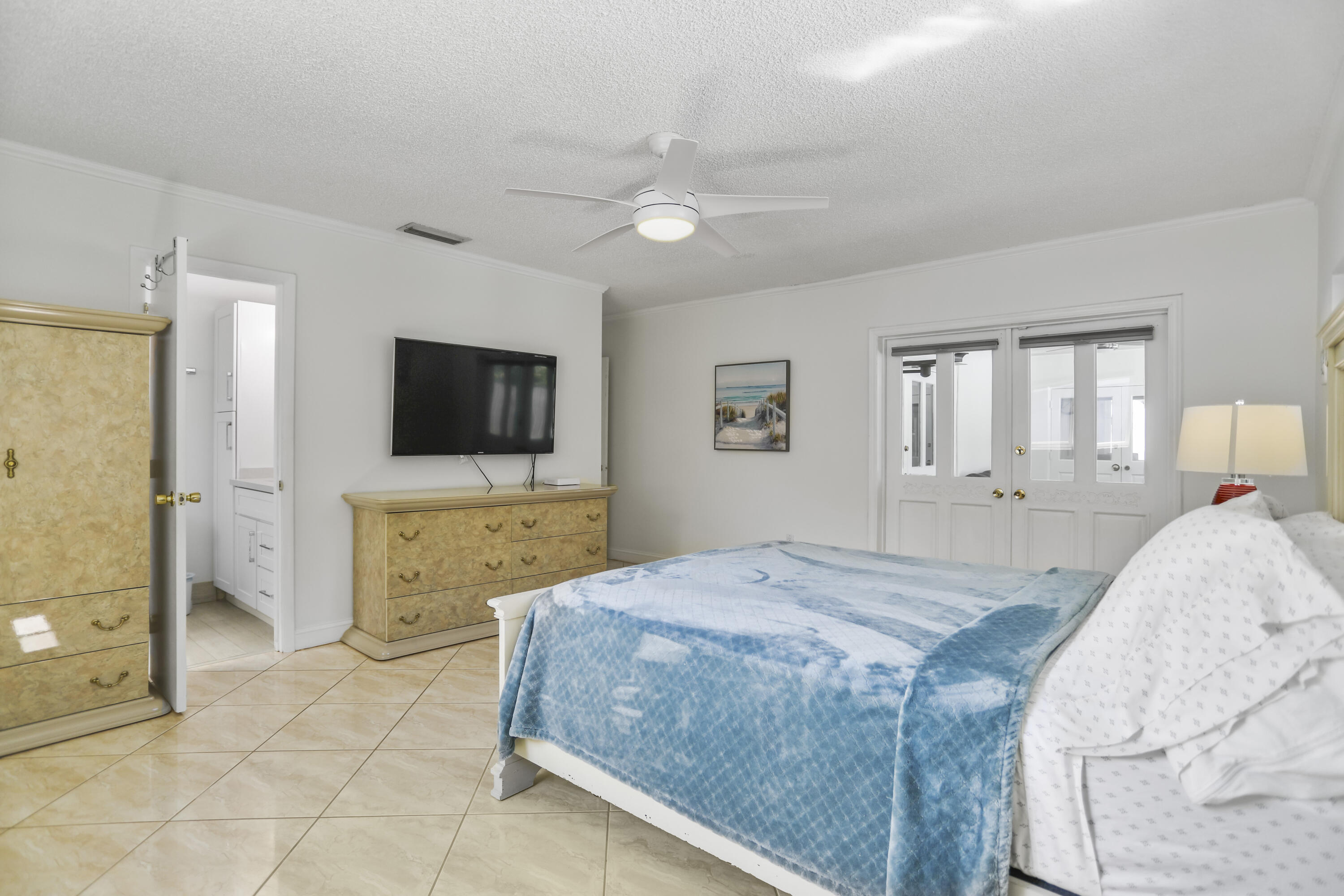 22682 Southwest 65th Avenue Boca Raton, FL 33428 - Photo 37 of 58 a bedroom with a bed and a flat screen tv