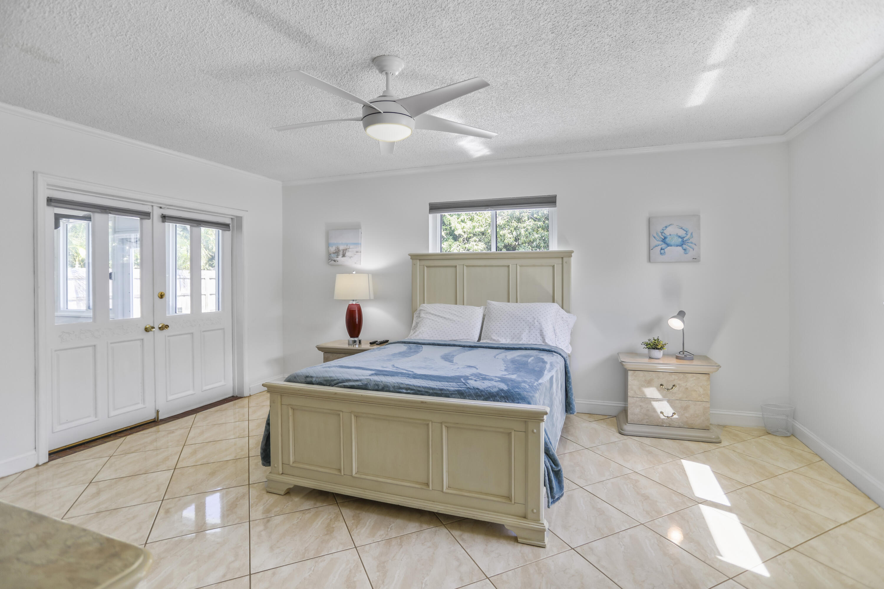 22682 Southwest 65th Avenue Boca Raton, FL 33428 - Photo 38 of 58 a bedroom with a bed and a chandelier