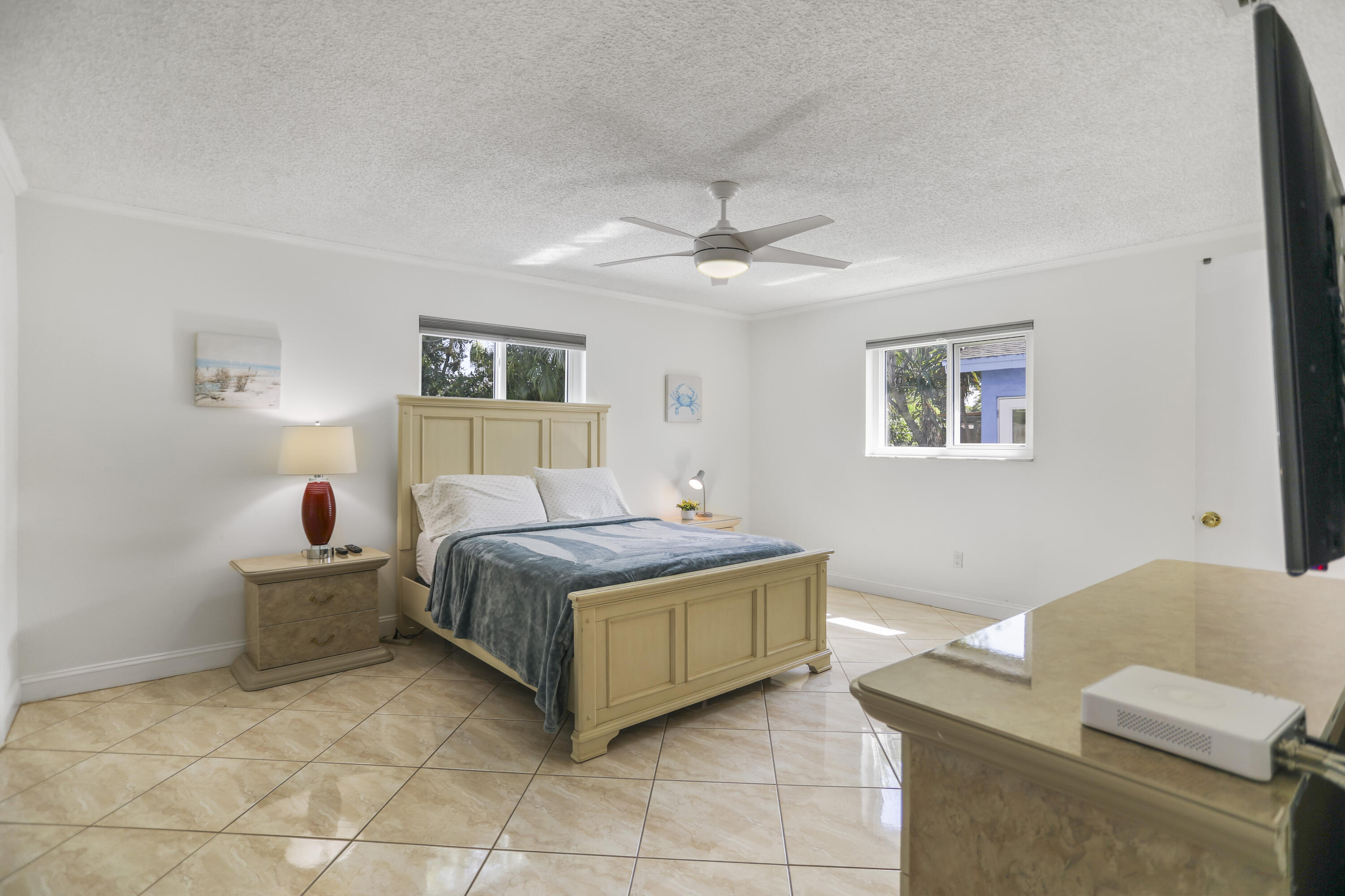 22682 Southwest 65th Avenue Boca Raton, FL 33428 - Photo 40 of 58 a living room with a bed furniture and painting on the wall