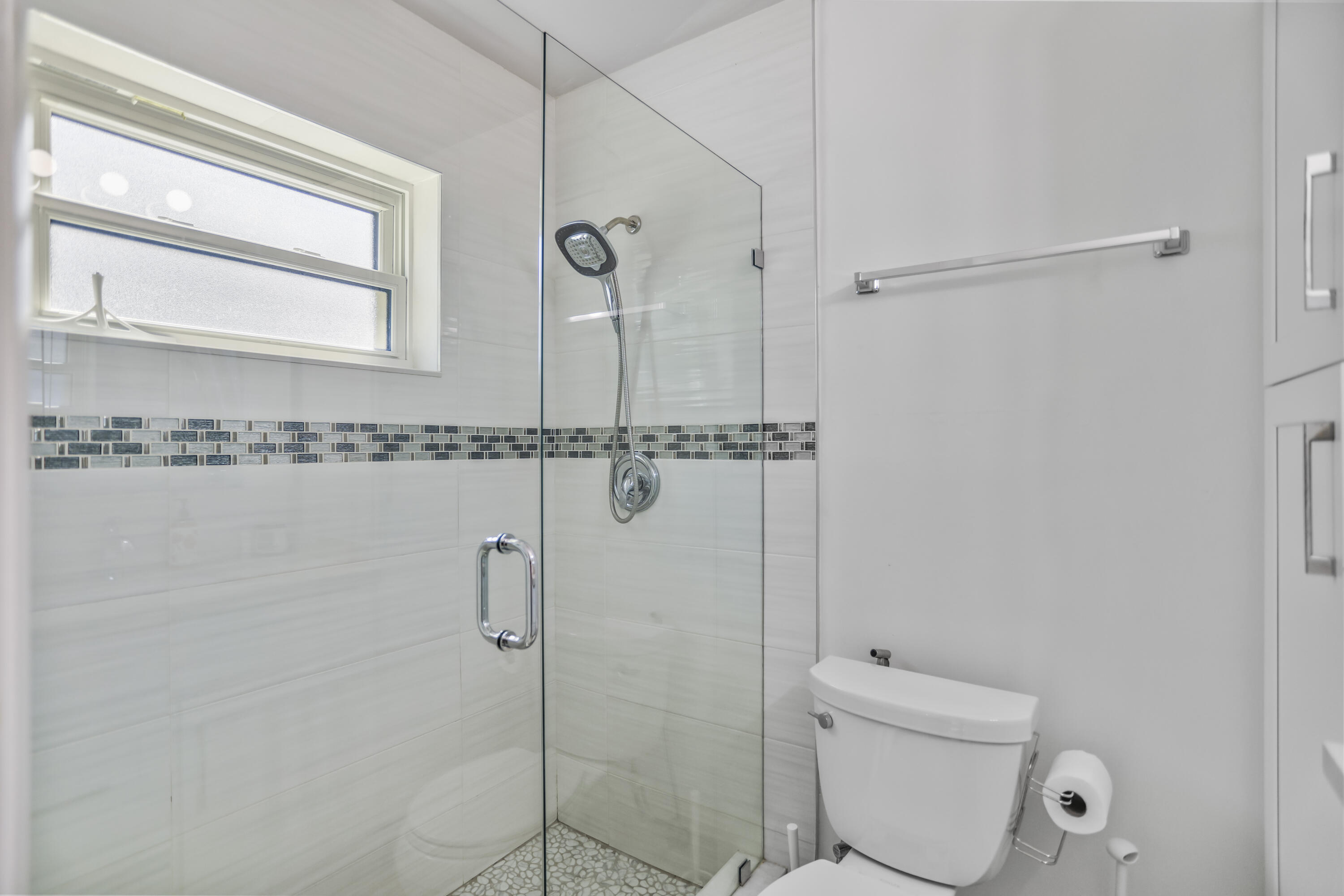 22682 Southwest 65th Avenue Boca Raton, FL 33428 - Photo 43 of 58 a bathroom with a shower a toilet and a window