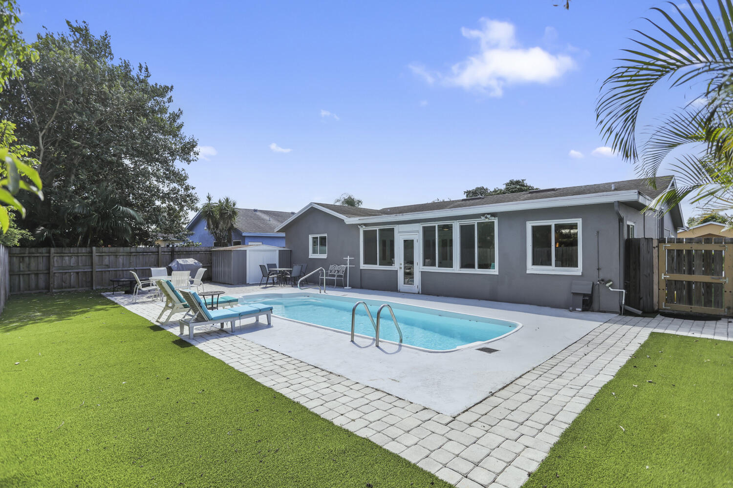 22682 Southwest 65th Avenue Boca Raton, FL 33428 - Photo 49 of 58 a view of a house with swimming pool and sitting area