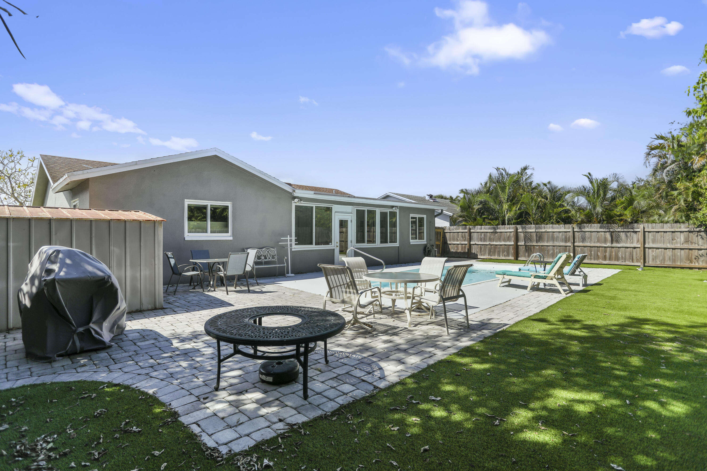 22682 Southwest 65th Avenue Boca Raton, FL 33428 - Photo 50 of 58 a view of a backyard with sitting area and fire pit