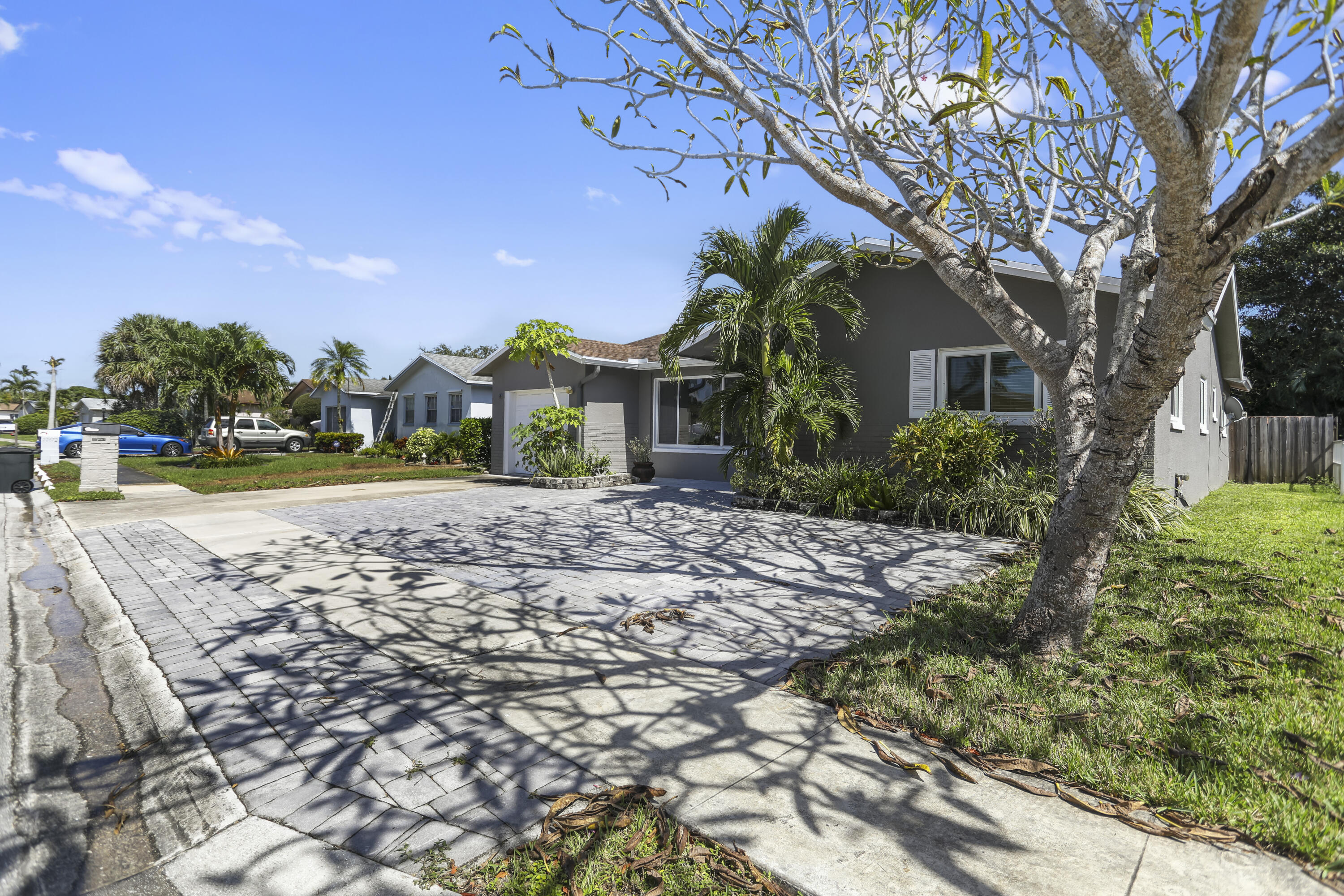 22682 Southwest 65th Avenue Boca Raton, FL 33428 - Photo 5 of 58 a front view of a house with garden
