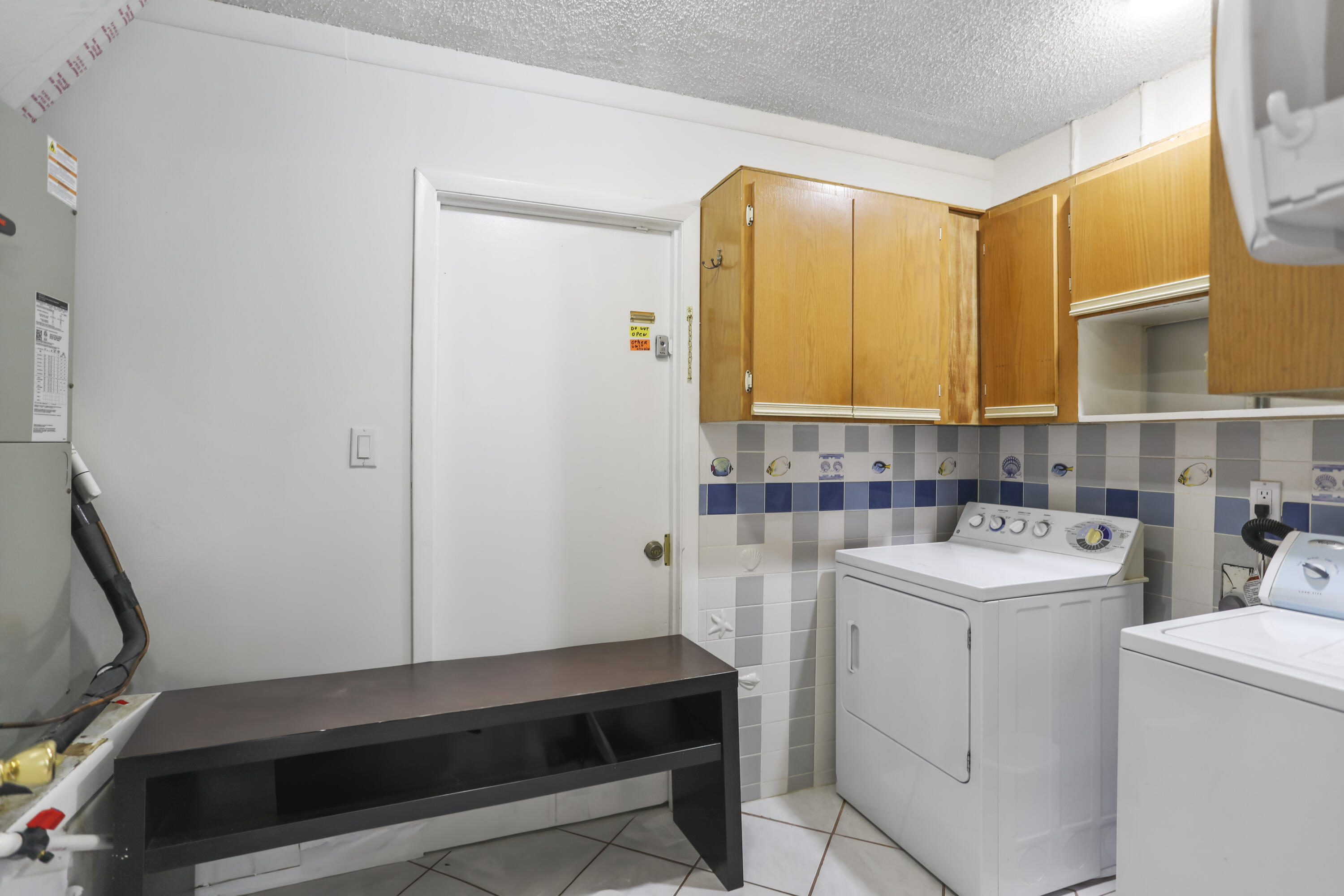 22682 Southwest 65th Avenue Boca Raton, FL 33428 - Photo 52 of 58 a view of utility room with washer and dryer