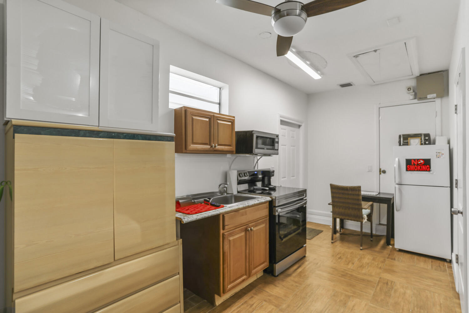 22682 Southwest 65th Avenue Boca Raton, FL 33428 - Photo 54 of 58 a kitchen with cabinets and white appliances