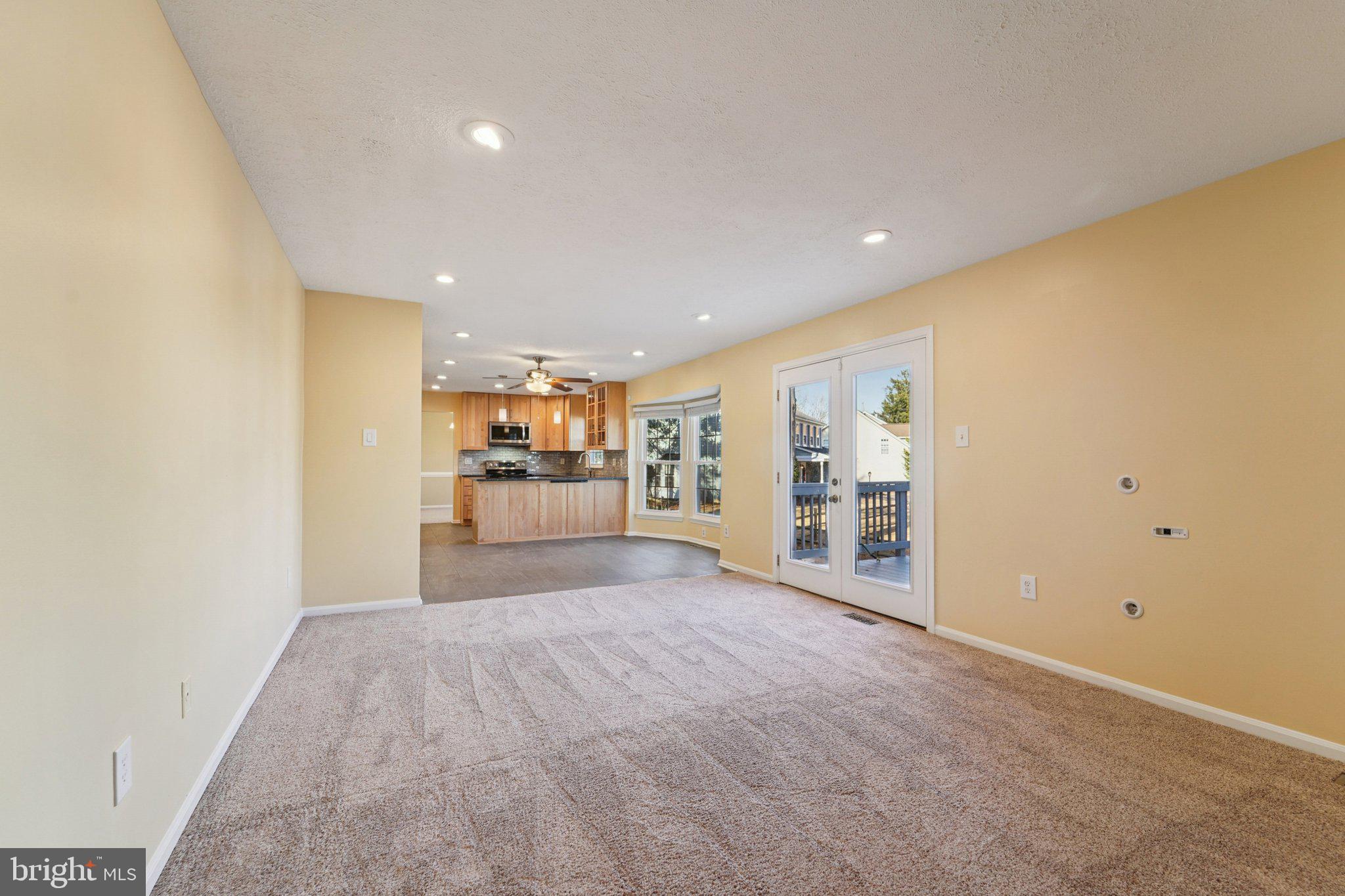 216 Bookham Lane Gaithersburg, MD 20877 - Photo 11 of 49 a view of a livingroom with wooden floor and a window