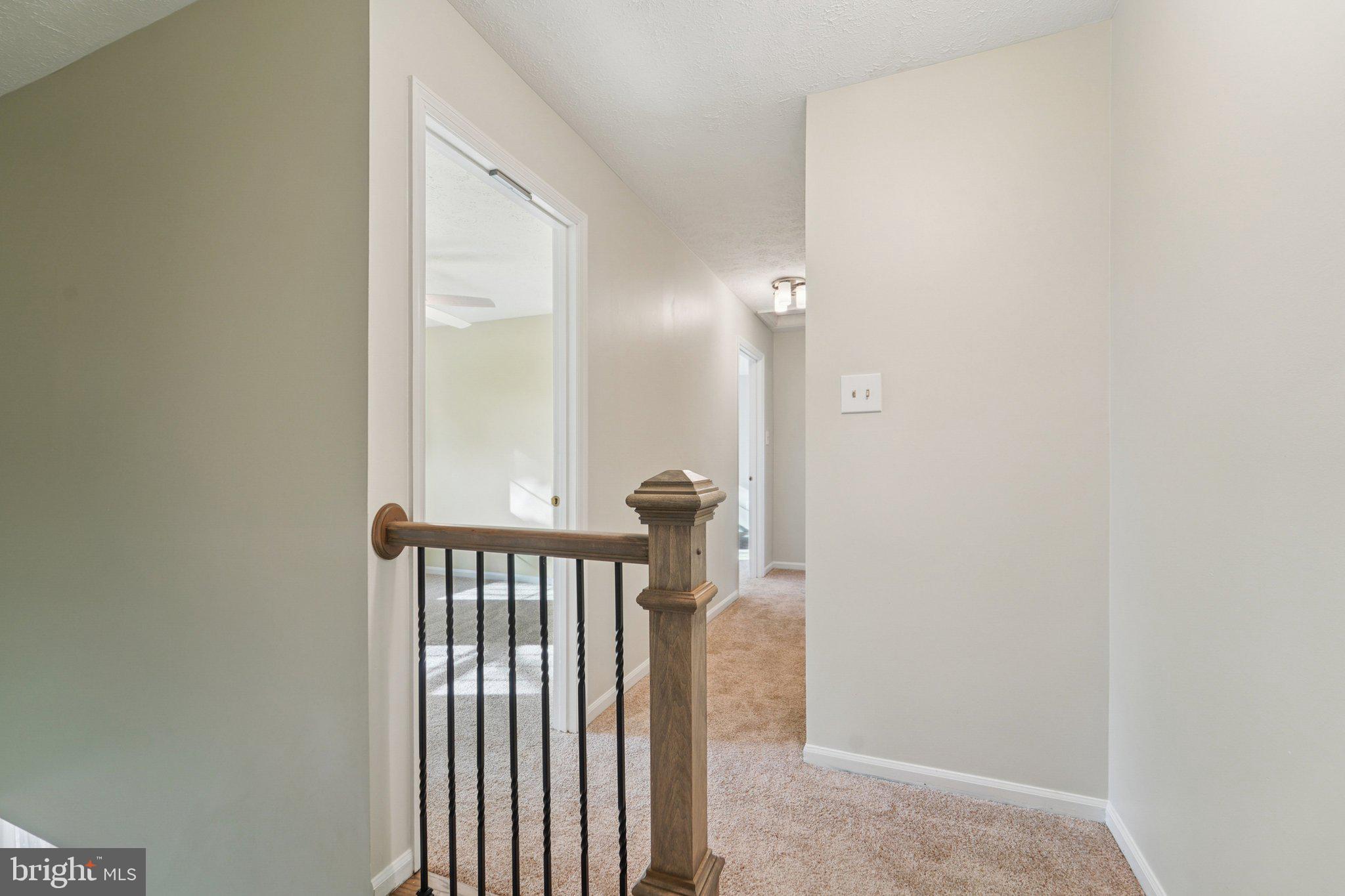 216 Bookham Lane Gaithersburg, MD 20877 - Photo 17 of 49 a view of a hallway with a door and a window