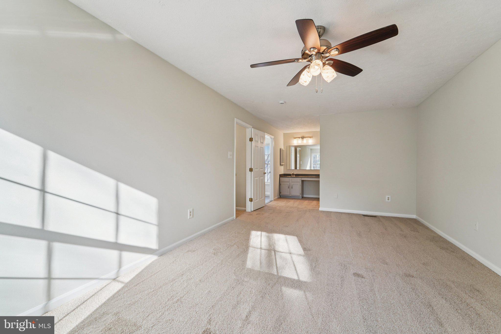 216 Bookham Lane Gaithersburg, MD 20877 - Photo 26 of 49 a view of empty room with wooden floor and fan