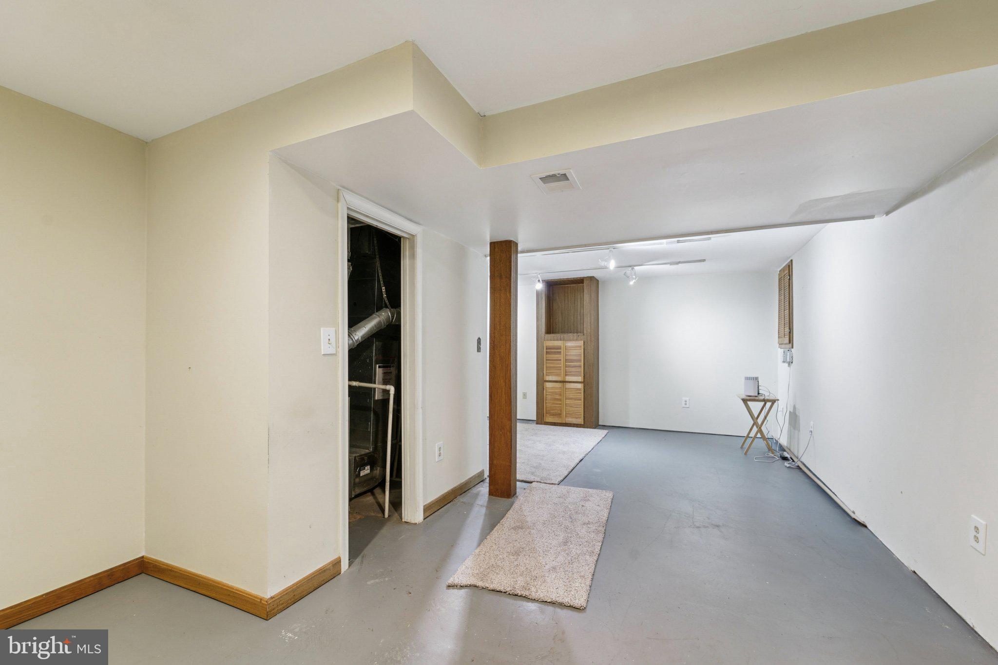 216 Bookham Lane Gaithersburg, MD 20877 - Photo 33 of 49 a view of an empty room and closet with wooden floor