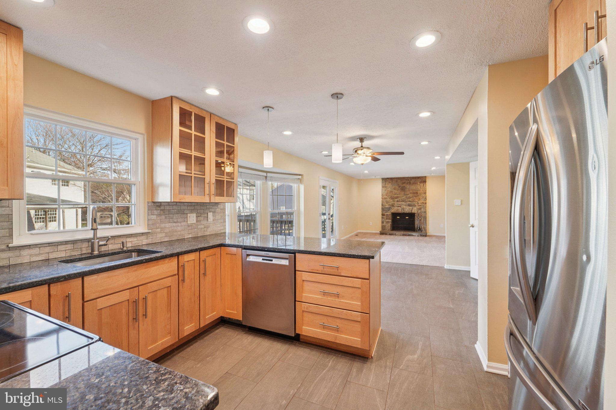 216 Bookham Lane Gaithersburg, MD 20877 - Photo 5 of 49 a large kitchen with stainless steel appliances granite countertop a refrigerator and a sink