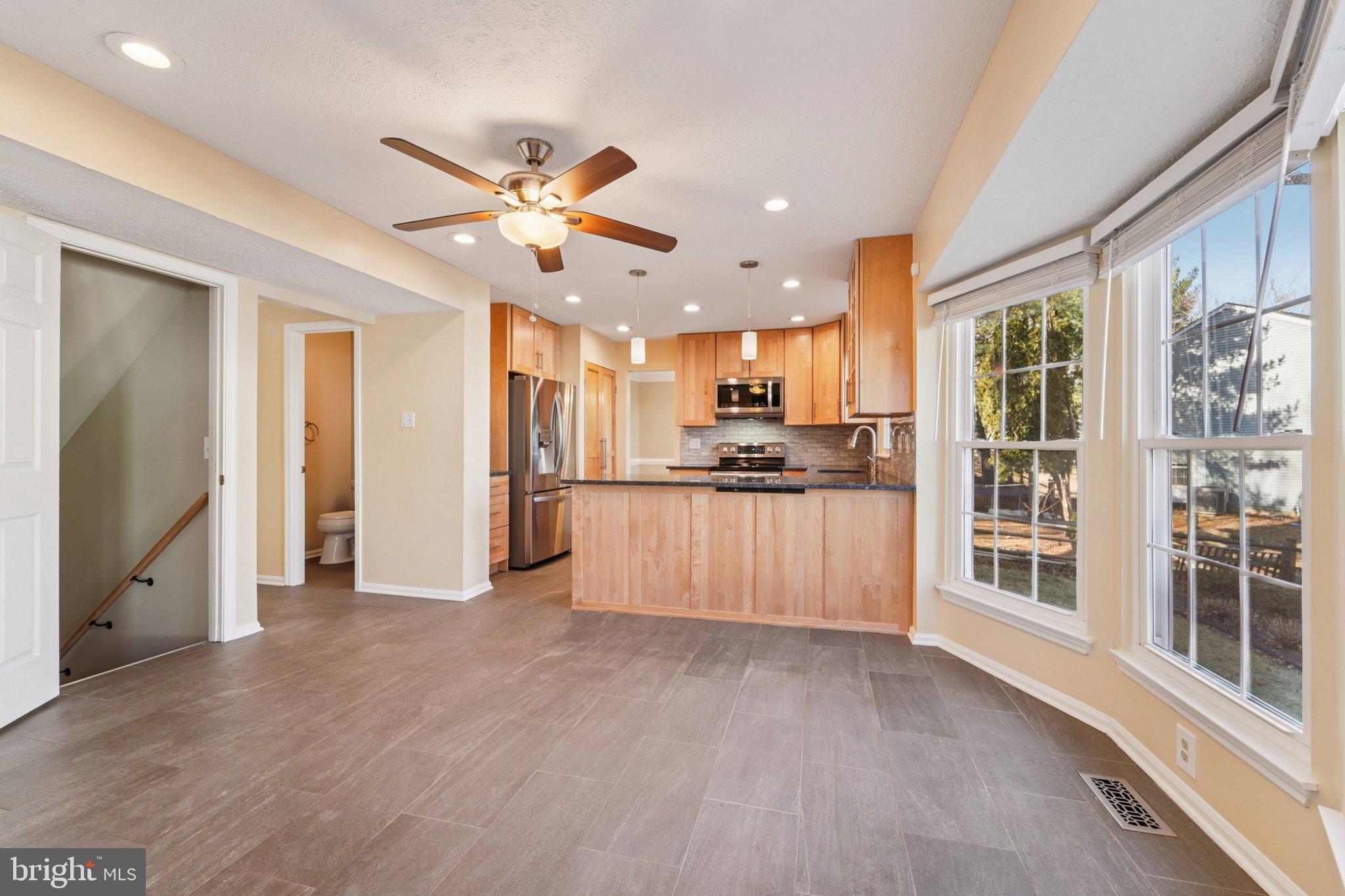 216 Bookham Lane Gaithersburg, MD 20877 - Photo 6 of 49 a view of kitchen with stainless steel appliances kitchen island wooden floor and window