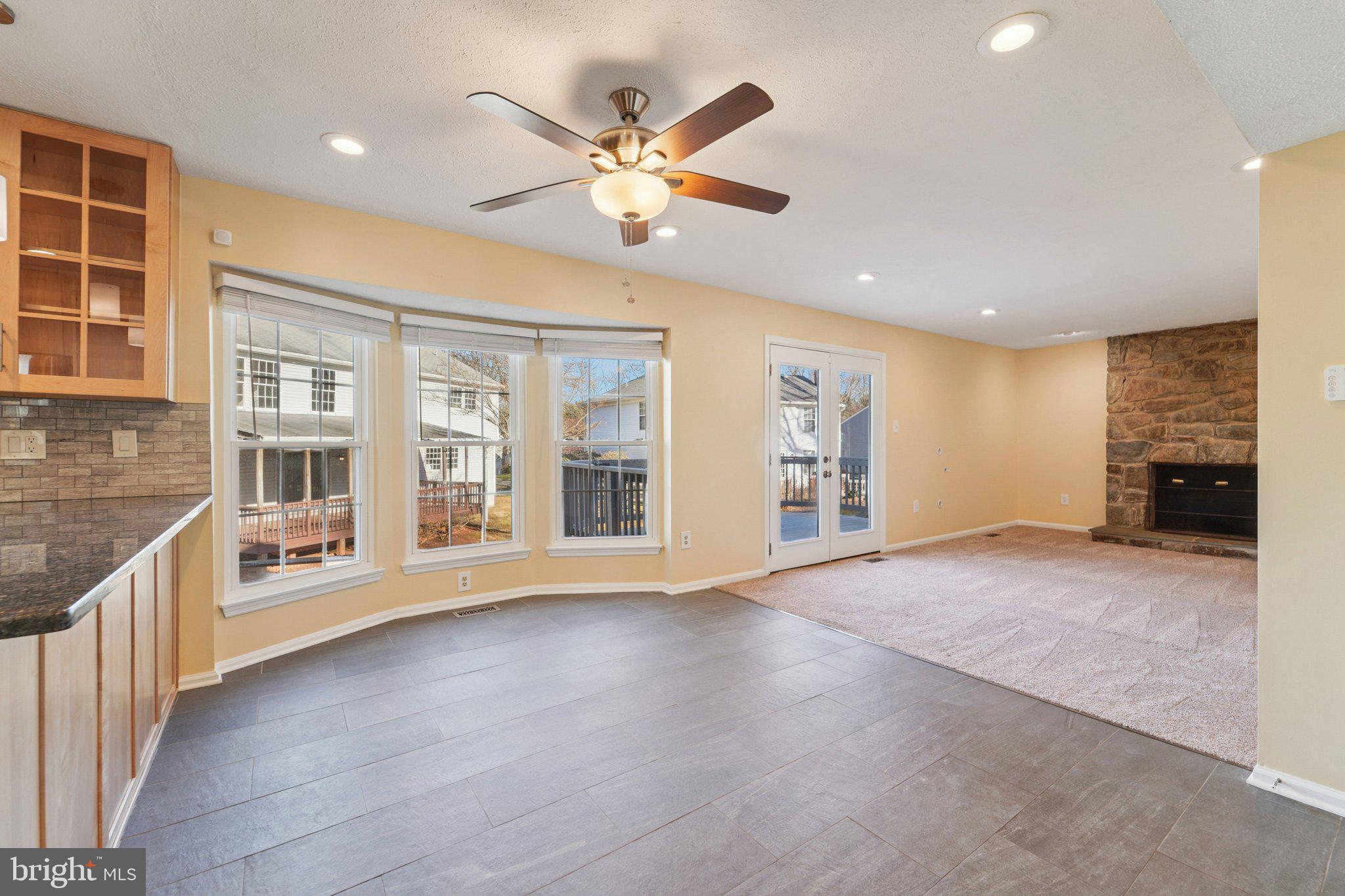 216 Bookham Lane Gaithersburg, MD 20877 - Photo 7 of 49 a view of an empty room with a window and wooden floor
