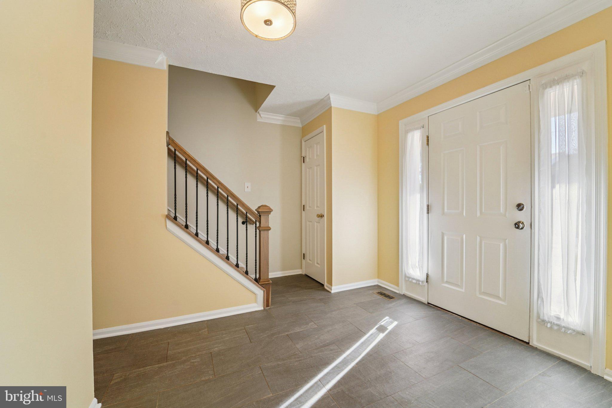 216 Bookham Lane Gaithersburg, MD 20877 - Photo 9 of 49 a view of a hallway with entryway with wooden floor