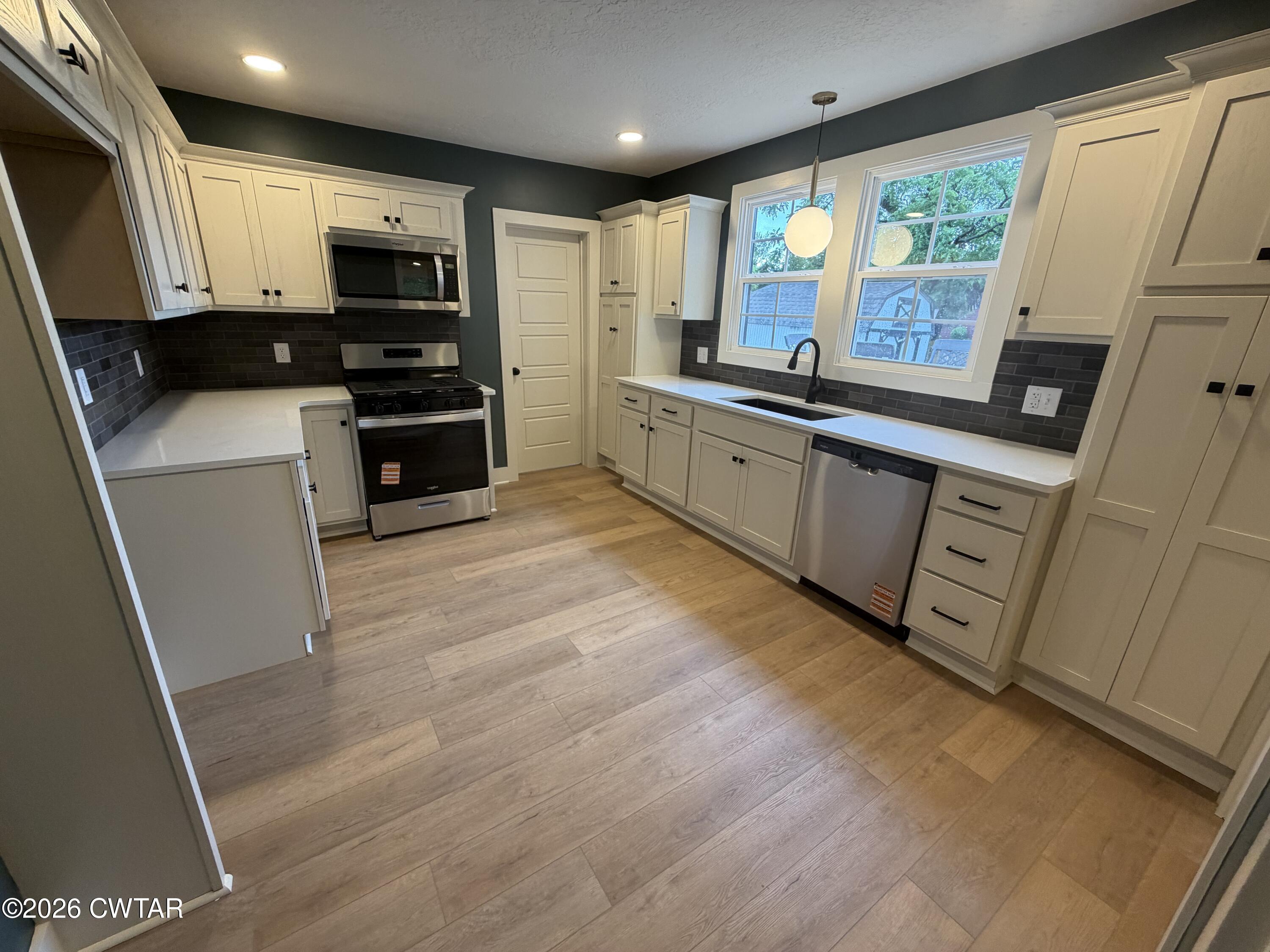 16 Manner Frank Road Milan, TN 38358 - Photo 9 of 25 a kitchen with stainless steel appliances a refrigerator sink and microwave