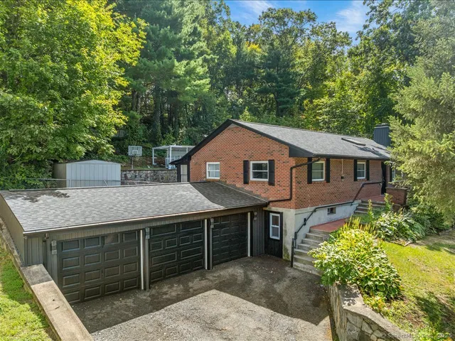 a aerial view of a house with a yard and potted plants