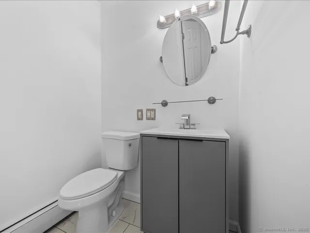 a bathroom with a sink toilet and mirror