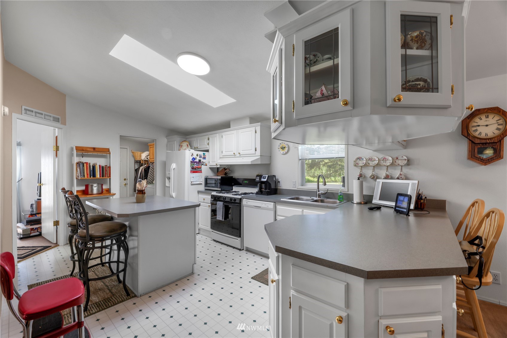 1761 Kaas Road Ferndale, WA 98248 - Photo 15 of 22 a kitchen with a sink a stove and chairs