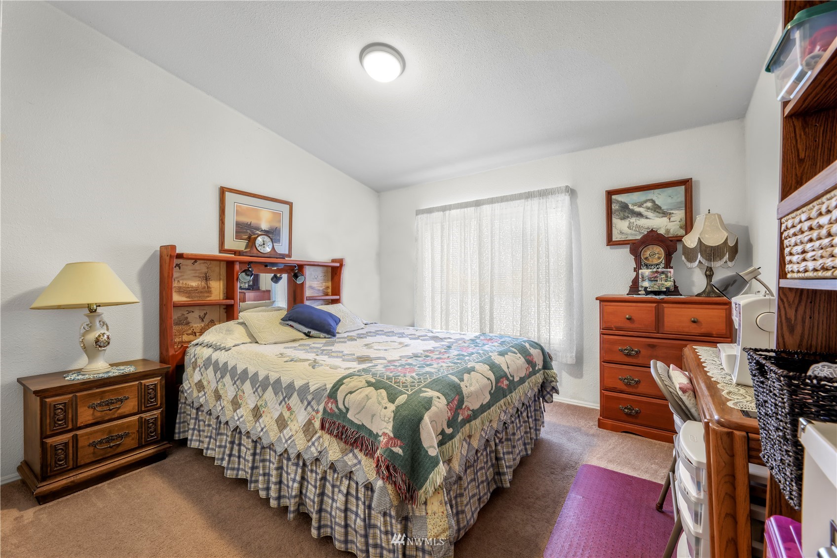 1761 Kaas Road Ferndale, WA 98248 - Photo 20 of 22 a bedroom with a bed and a chandelier