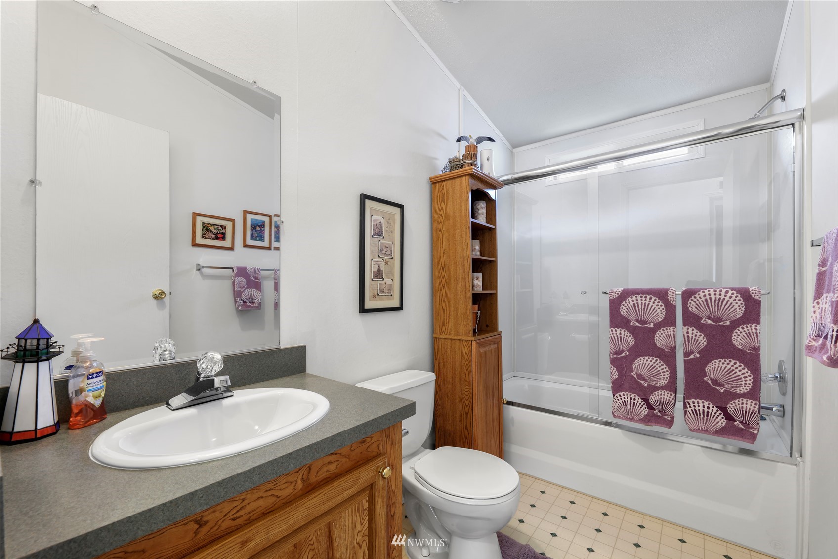 1761 Kaas Road Ferndale, WA 98248 - Photo 22 of 22 a bathroom with a sink a toilet a mirror and shower