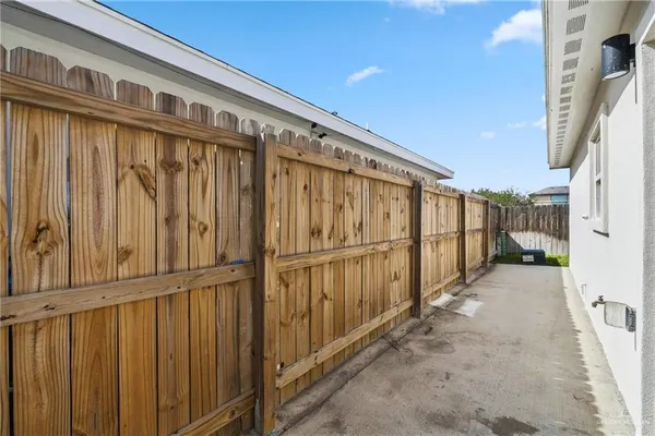 a view of a house with wooden fence