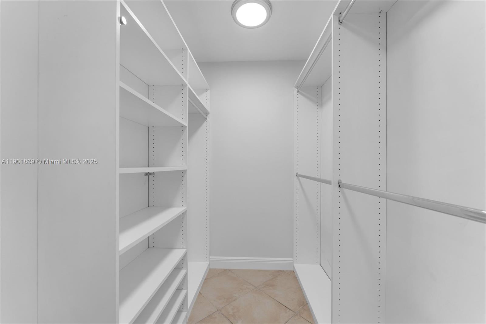 14512 Southwest 138th Court Miami, FL 33186 - Photo 14 of 28 a view of walk in closet with empty racks