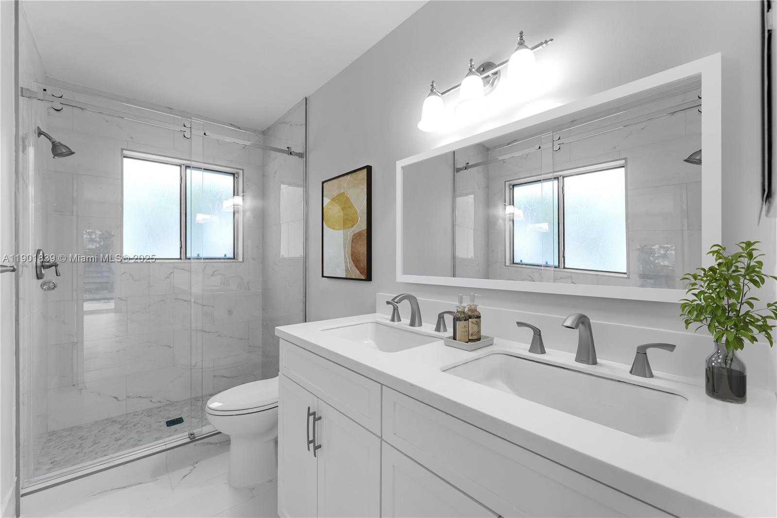 14512 Southwest 138th Court Miami, FL 33186 - Photo 15 of 28 a bathroom with a sink a toilet and shower