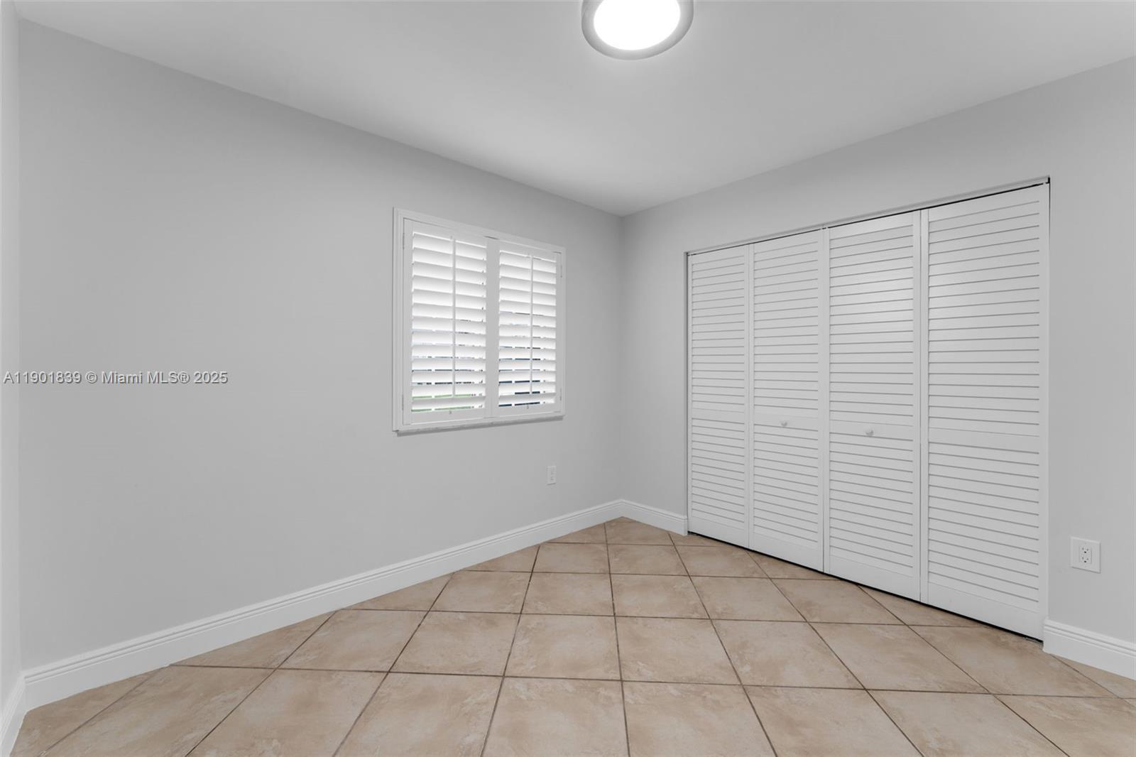 14512 Southwest 138th Court Miami, FL 33186 - Photo 17 of 28 a view of an empty room with a window