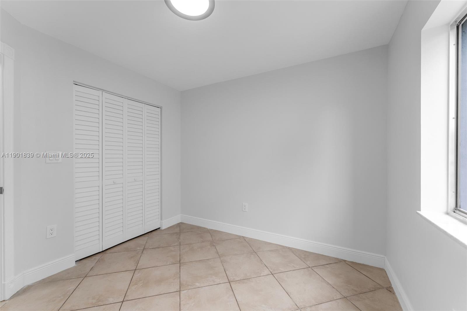 14512 Southwest 138th Court Miami, FL 33186 - Photo 20 of 28 a view of an empty room and window