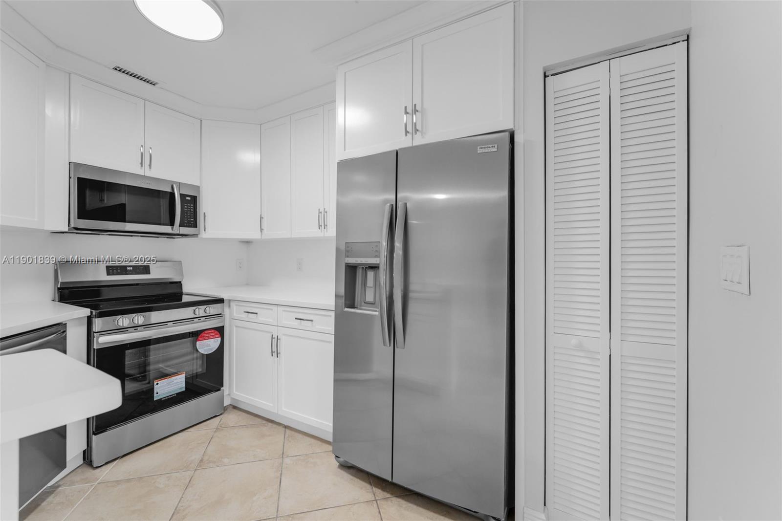 14512 Southwest 138th Court Miami, FL 33186 - Photo 9 of 28 a kitchen with stainless steel appliances granite countertop a refrigerator and a stove top oven
