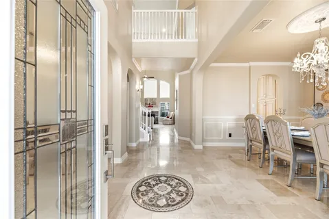 a view of a hallway with furniture and a dining table