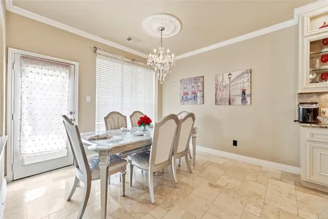 a view of a dining room with furniture and chandelier