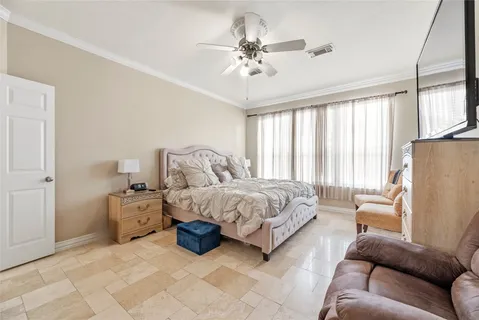 a spacious bedroom with a bed and window