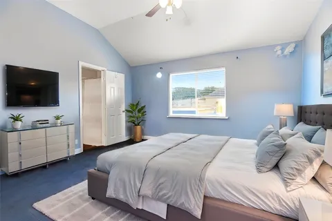 a bedroom with a bed and a flat screen tv