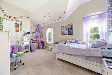 a bedroom with bed and a window