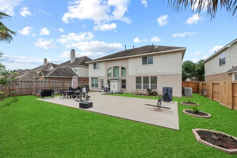 a view of a house with backyard and sitting area