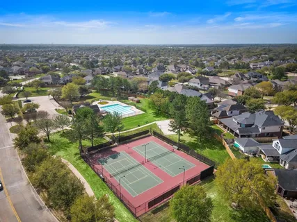 an aerial view of a pool yard and mountain view in back