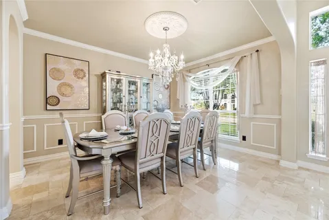 a view of a dining room with furniture large window and chandelier