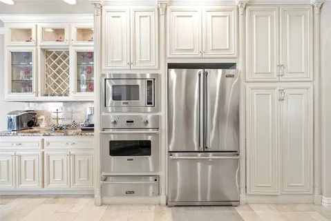 a kitchen with white cabinets and white appliances