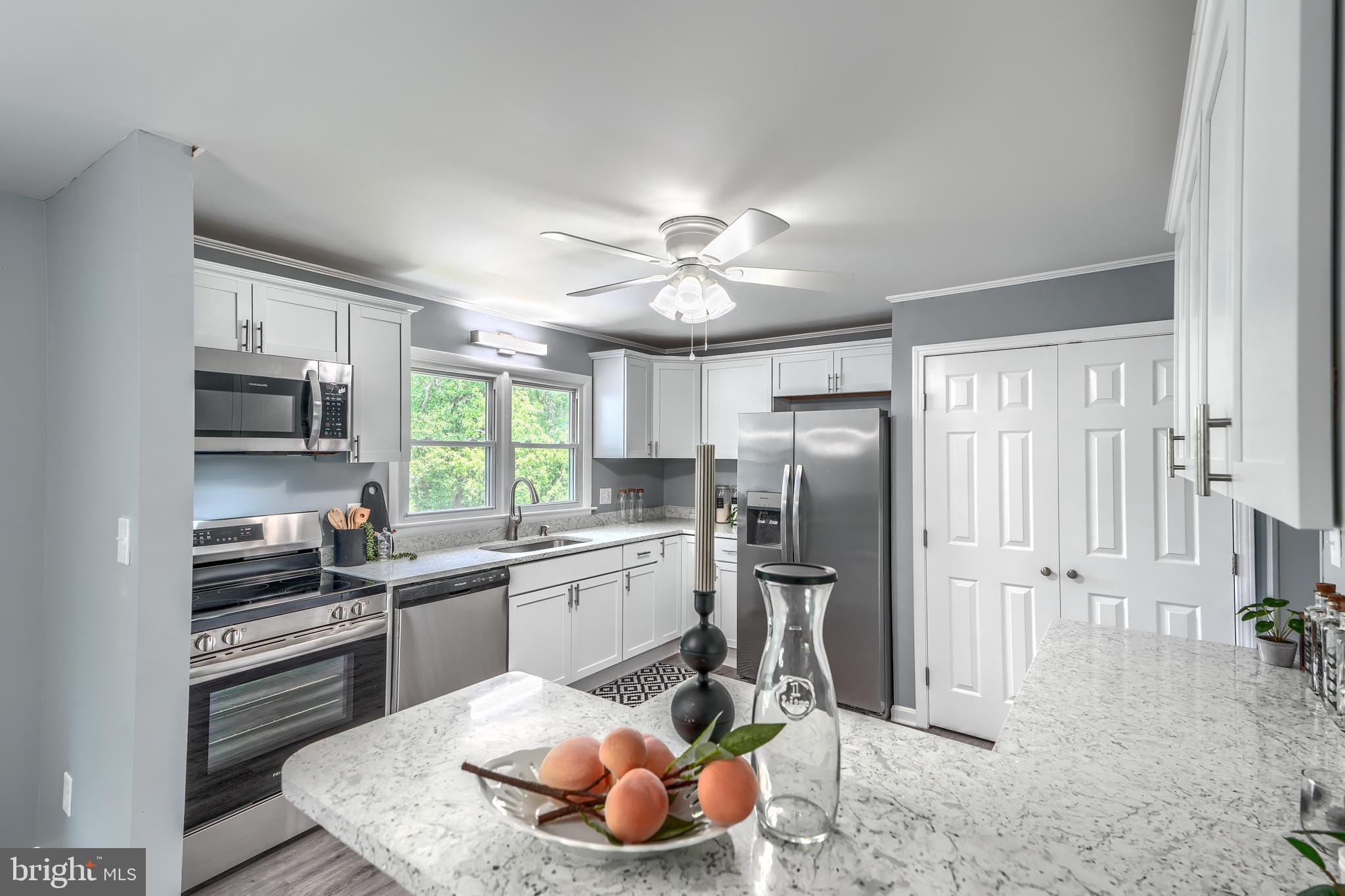 8020 Redstone Road Kingsville, MD 21087 - Photo 17 of 50 a kitchen with stainless steel appliances granite countertop a sink stove and refrigerator