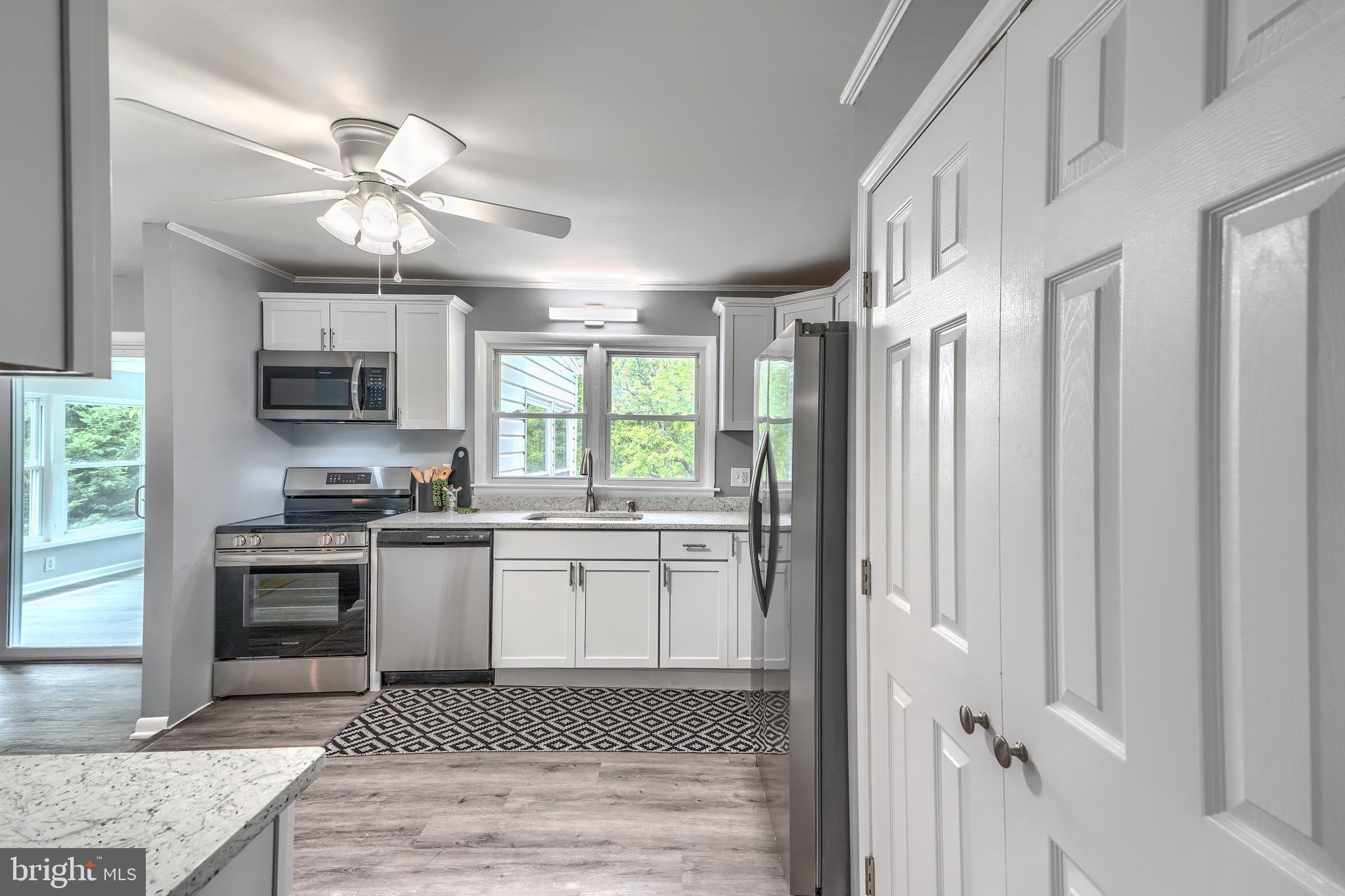 8020 Redstone Road Kingsville, MD 21087 - Photo 19 of 50 a kitchen with a stove a sink and a refrigerator