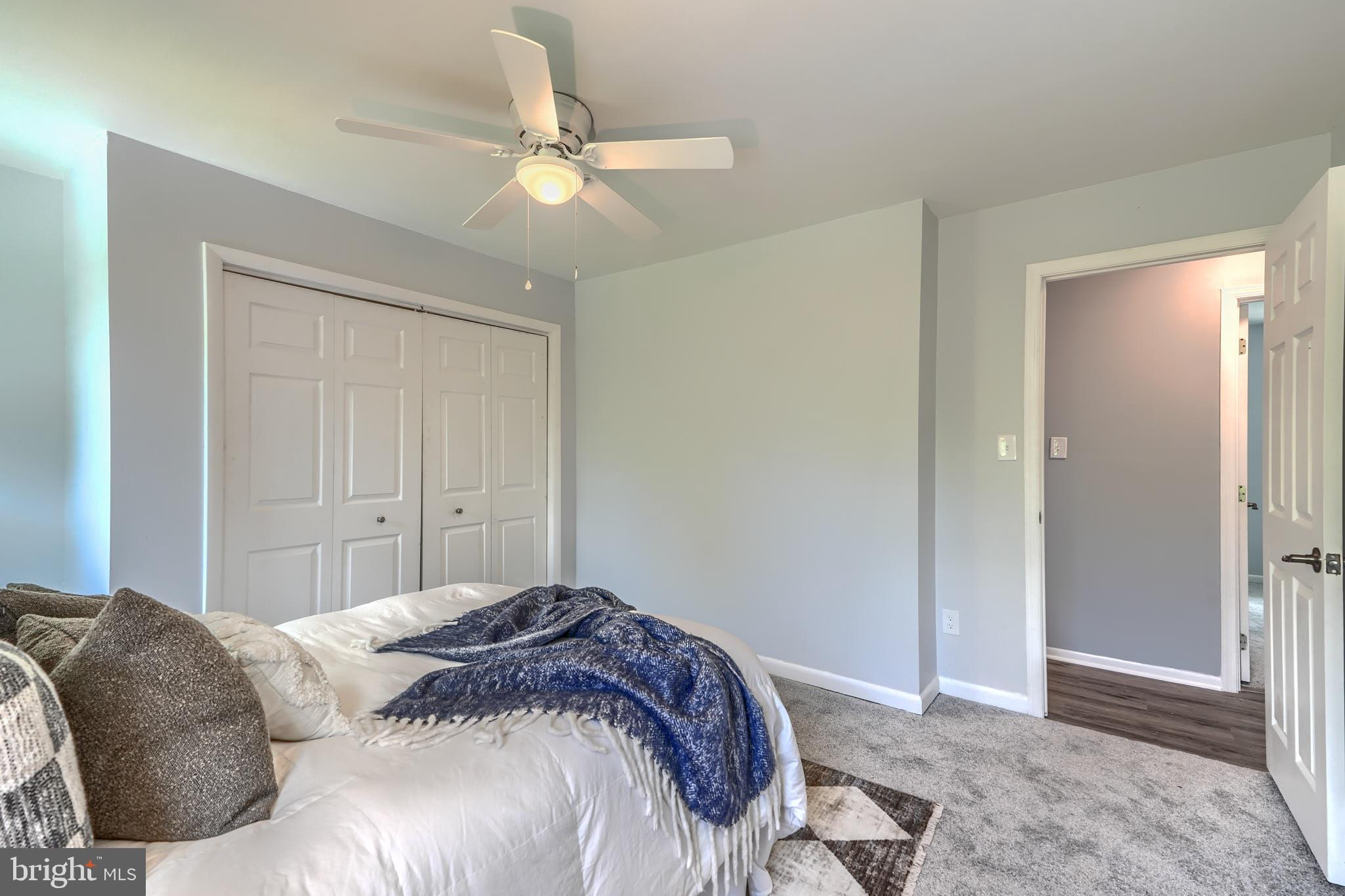 8020 Redstone Road Kingsville, MD 21087 - Photo 26 of 50 a bedroom with a bed and a chandelier