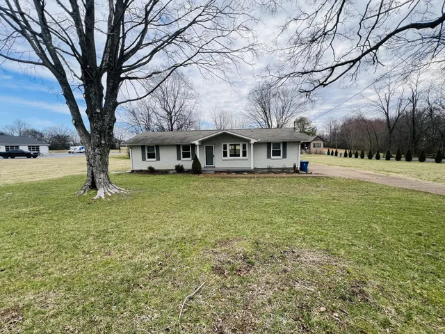 a view of house with outdoor space and garden