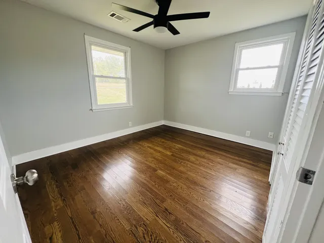 wooden floor in an empty room with a window