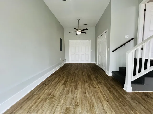 a view of a hallway with wooden floor